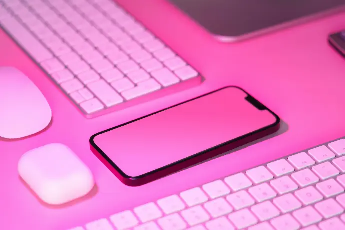 a cell phone sitting on top of a keyboard